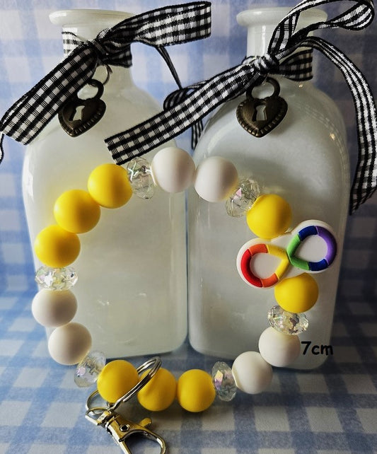 Wristlet Keychains made of 15mm Yellow and white beads with an autism infinity focal bead